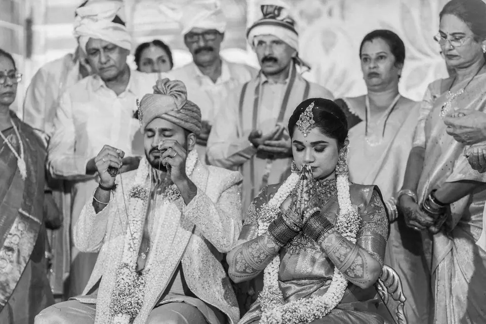 Black and white: the couple laughing at the centre of a crowd of family