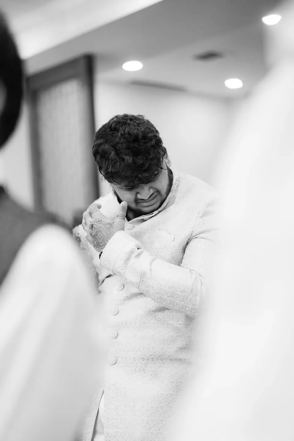 Black and white: the groom covering his eyes, overcome
