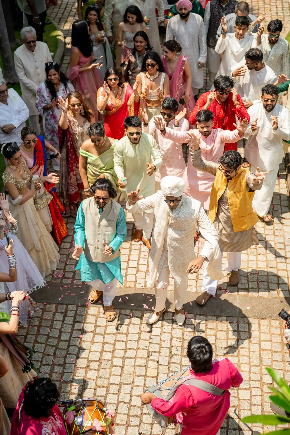 The procession seen from above, a crowd of colour on the stone courtyard