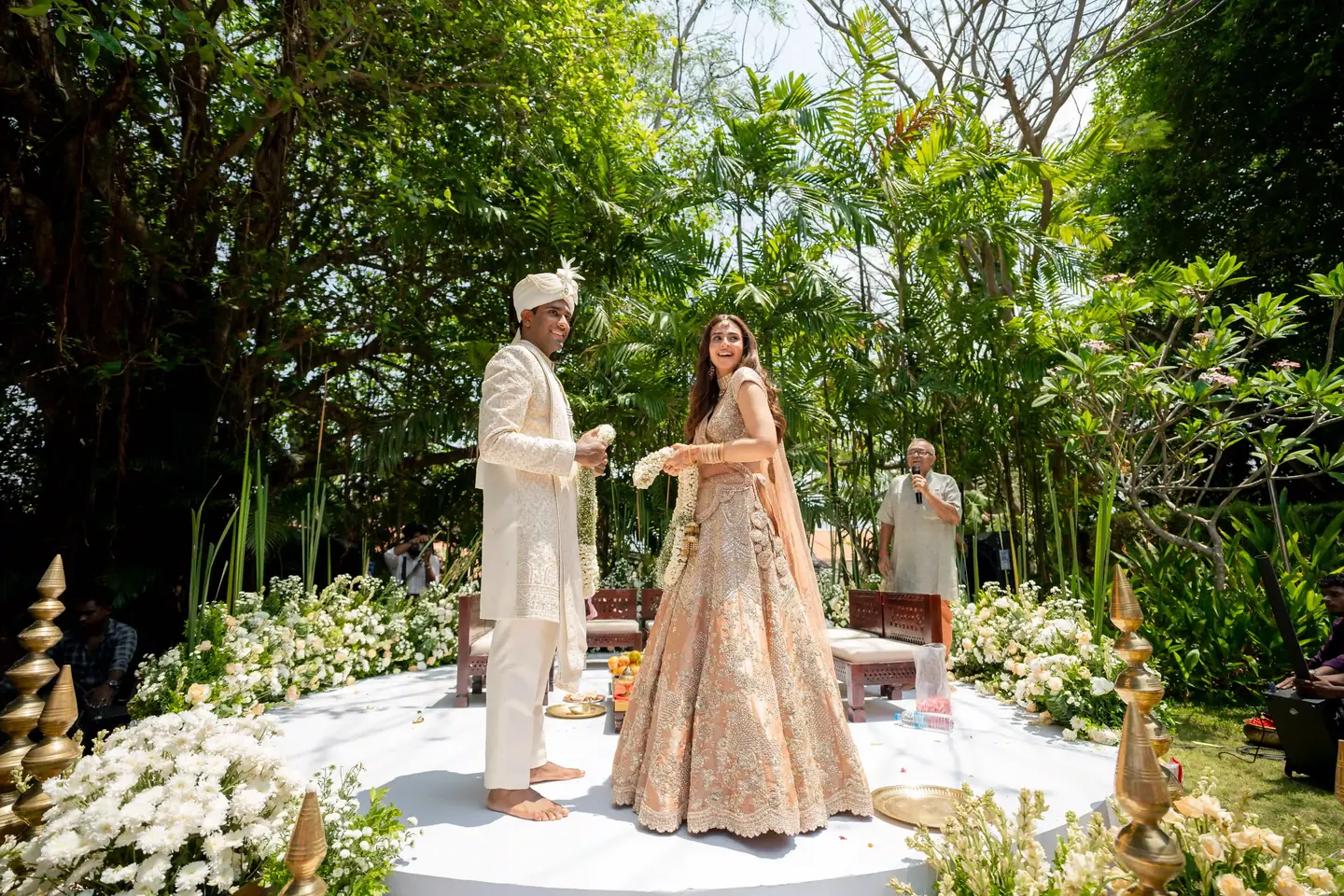 Kabir & Rhea on a round white mandap ringed with flowers