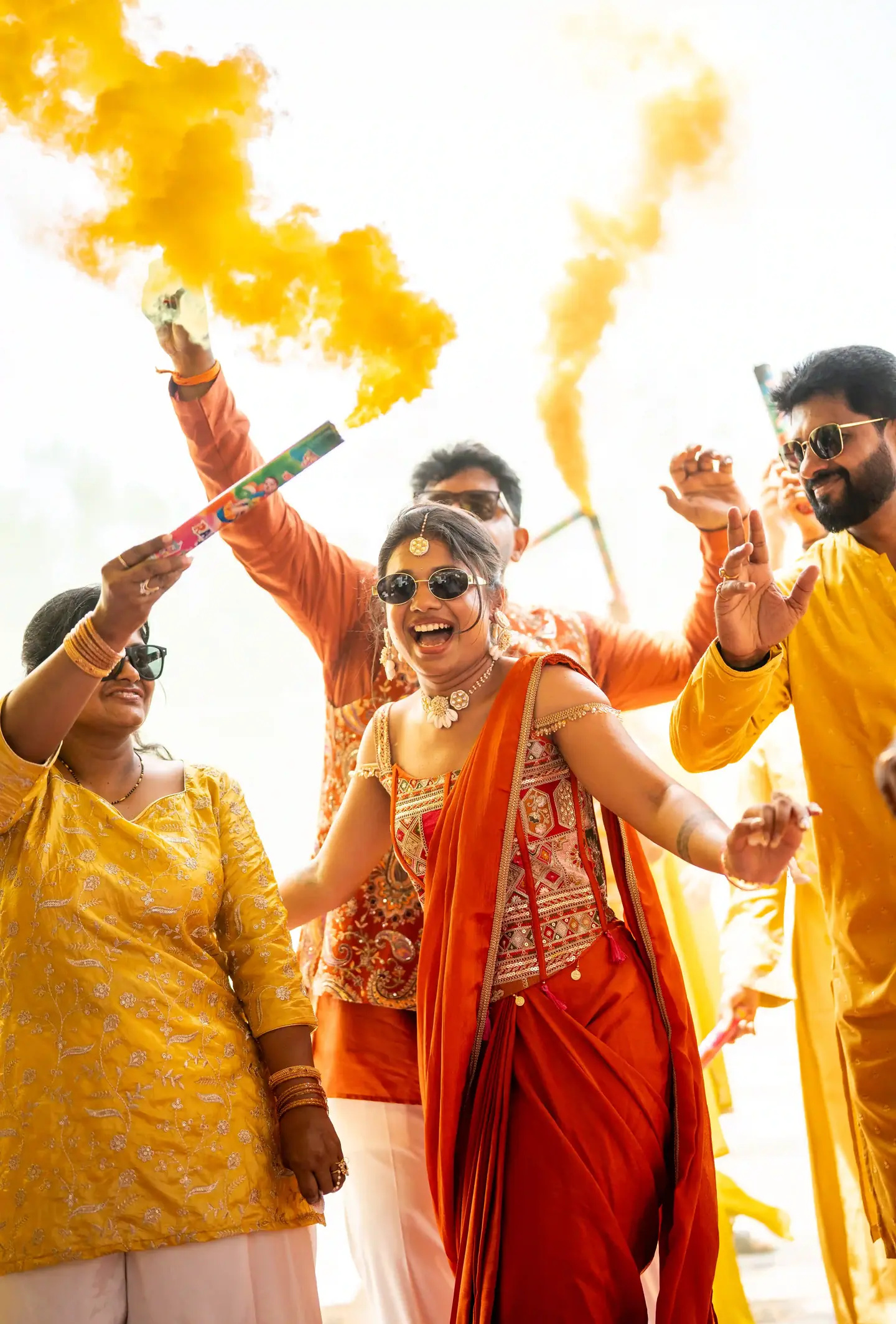 The bride laughing through clouds of yellow smoke