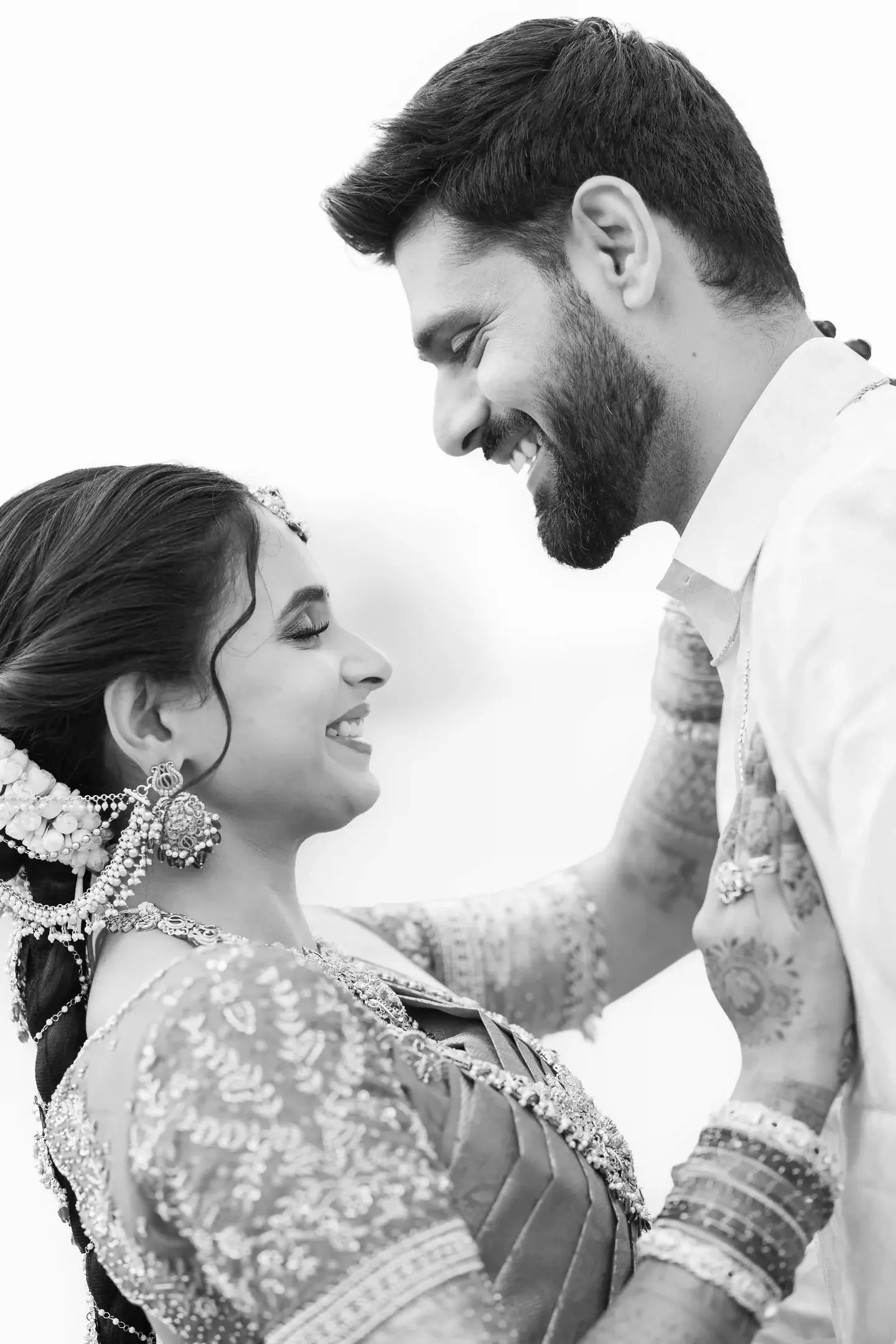 Black and white: the groom smiling down at the bride