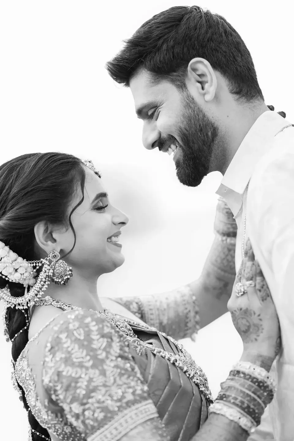 Black and white: the groom smiling down at the bride