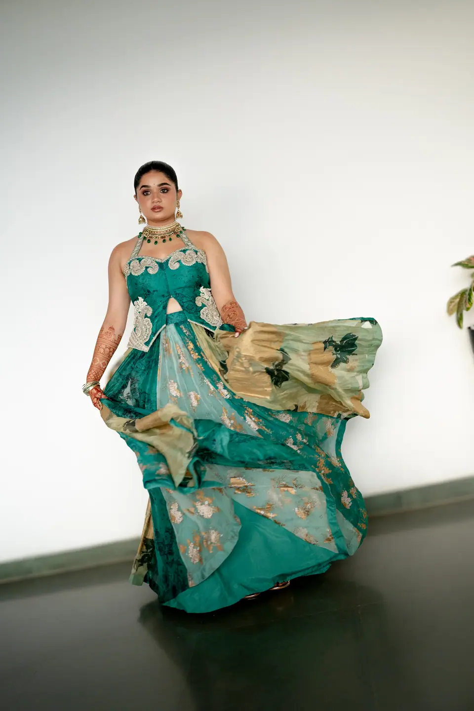 The bride swirling her printed teal skirt in a white room