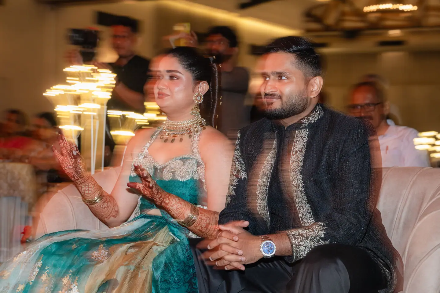 Pranav & Shreya laughing from the front row at their sangeet