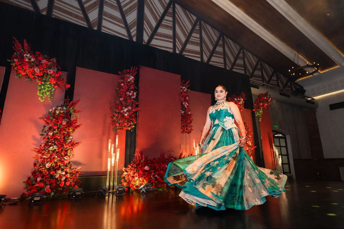 Shreya in a teal lehenga twirling alone on the sangeet stage