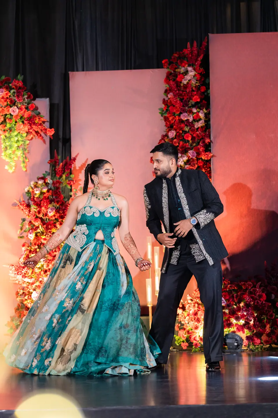 Pranav and Shreya dancing together on the sangeet stage